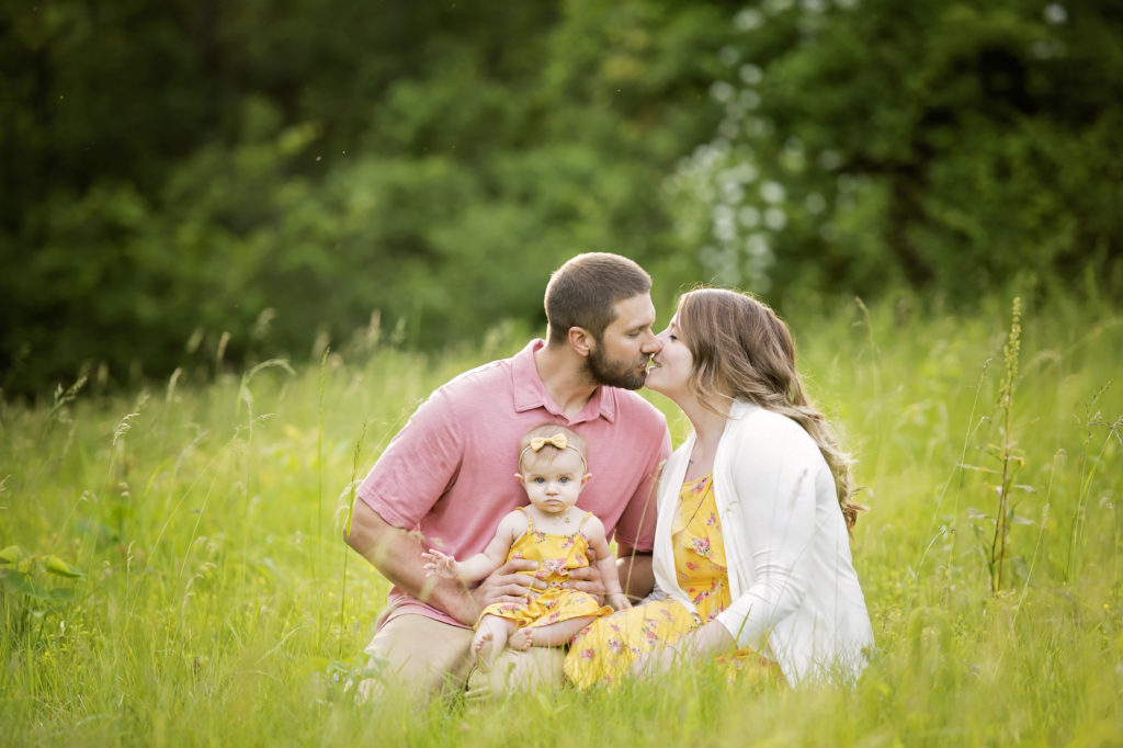 candid outdoor family photo in grass