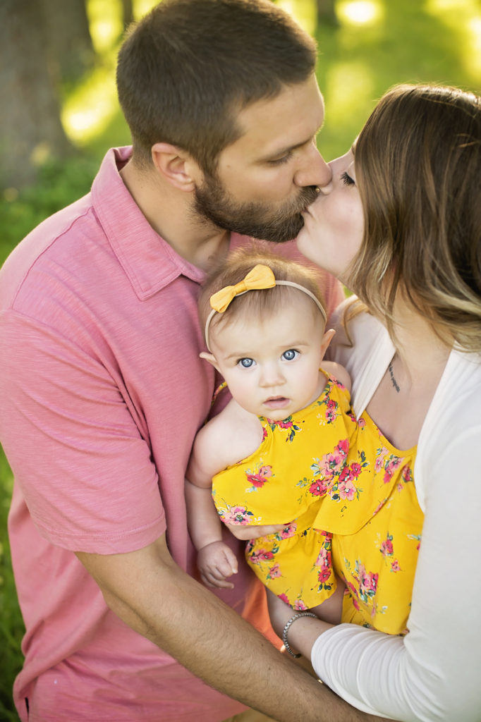 husband and wife with baby in saratoga springs
