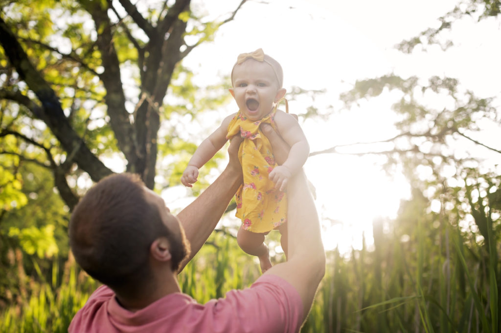 father holding daughter up